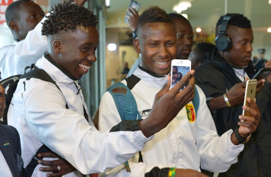 Mali team-mates Fousseyni Diabate (left) and Alassane Diallo compare photographs during the team...