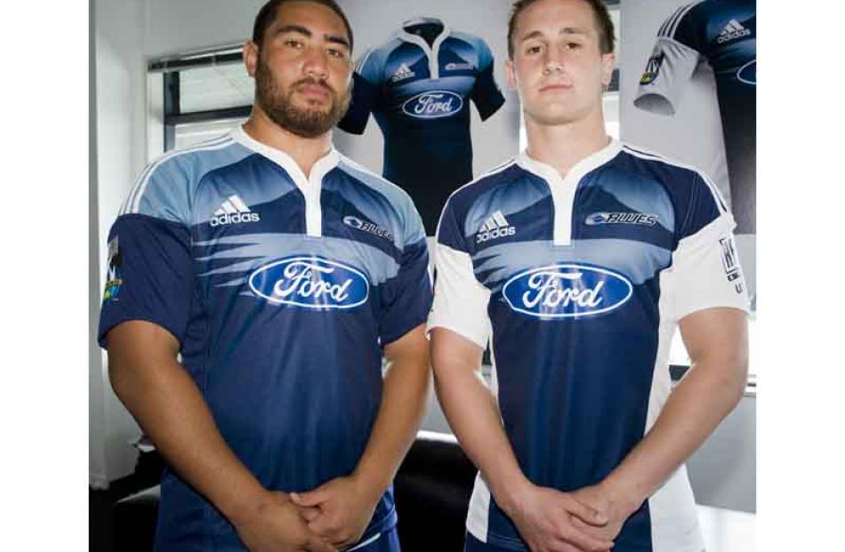 Charlie Faumuina and Michael Hobbs wear the new Super 14 Blues home and away jerseys from sports...