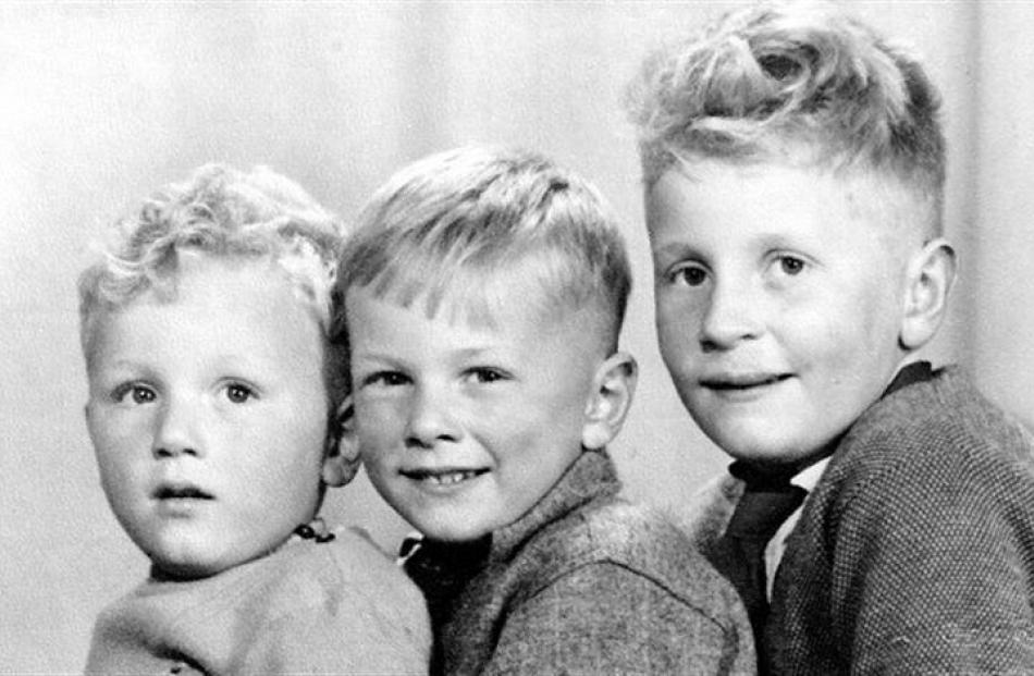 Lee Vandervis (aged about 8) flanked by his brothers. Supplied photo.