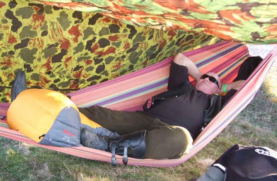 Keith Turner, of Roxburgh, sleeps in a hammock under a fly on his eighth rally and the eighth...