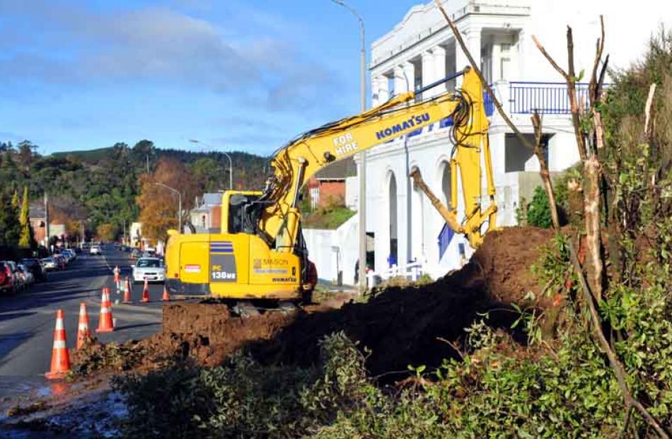 A digger works to clear a slip on Duke St.