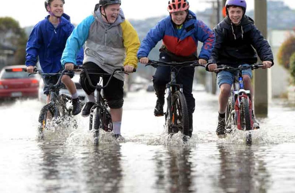Cycling on a flooded Bayview Rd, South Dunedin yesterday (from left) Jevon McFalane (13), Tyler...