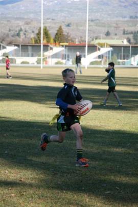 Year 5-6 Maniototo Blue player Josh Smith (11) goes for the try.