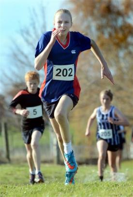 Ella Scott (14), of Queen's High School, sprints for the finish line in the under-15  girls race.