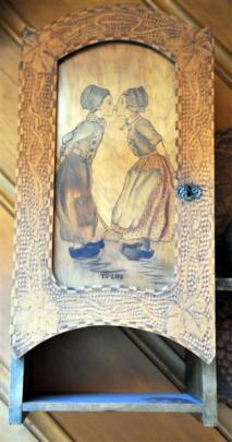 This small pokerwork shelf was decorated by burning a design into the wood with a heated metal...