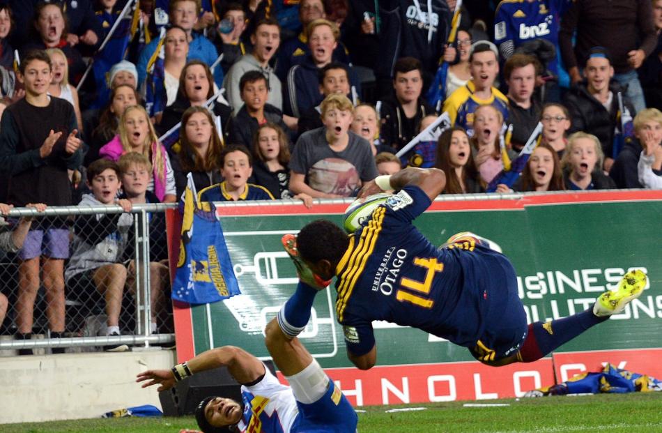 Highlanders fans show their delight as blockbusting winger Waisake Naholo goes over the top of...