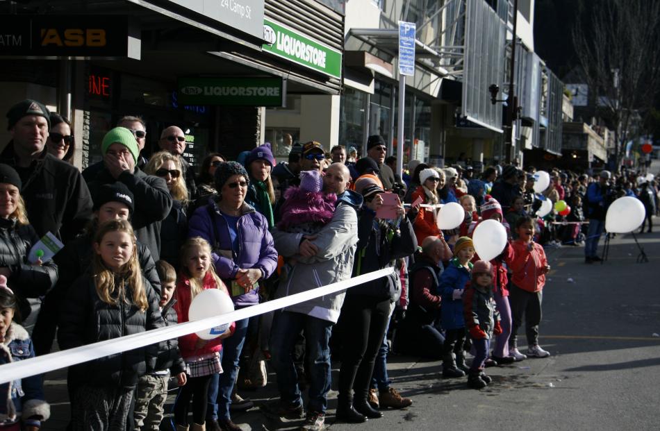 Crowds watch the parade at the Queenstown Winter Festival on Saturday.