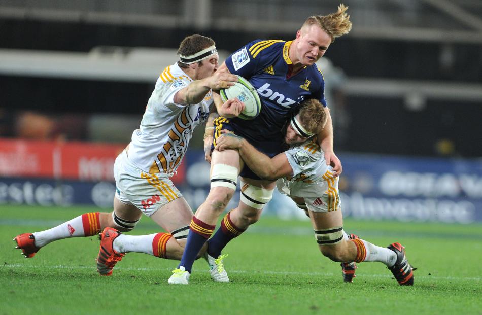 Garth Evans tackled by Brodie Retallick and Sam Cane 
...