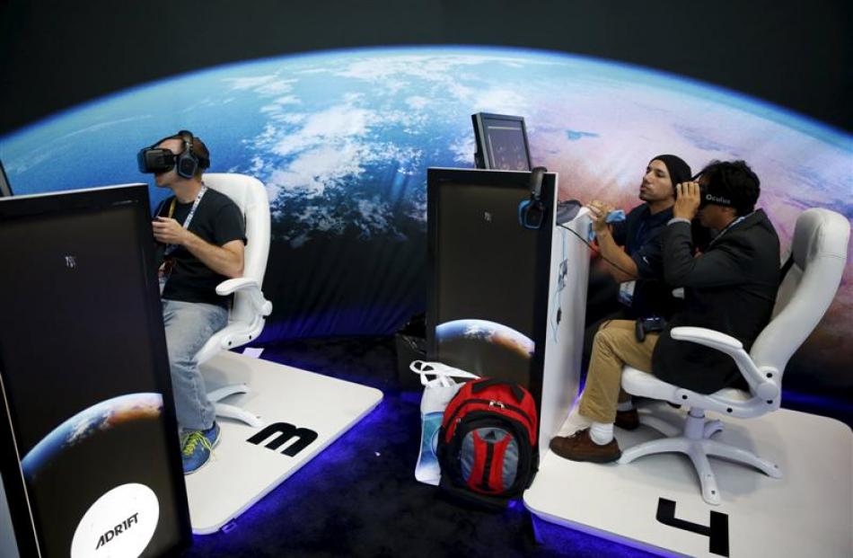 People wear Oculus VR headsets as they play Three One Zero's Adr1ft game.