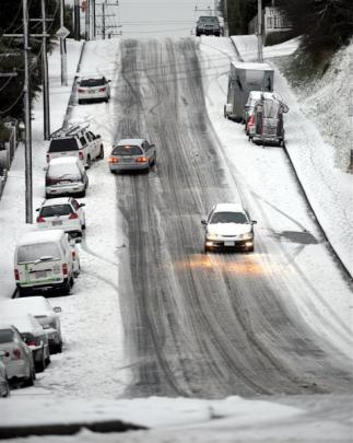 Cars struggle for traction on the ice in Wakari Rd yesterday morning. Photo by Gerard O'Brien.