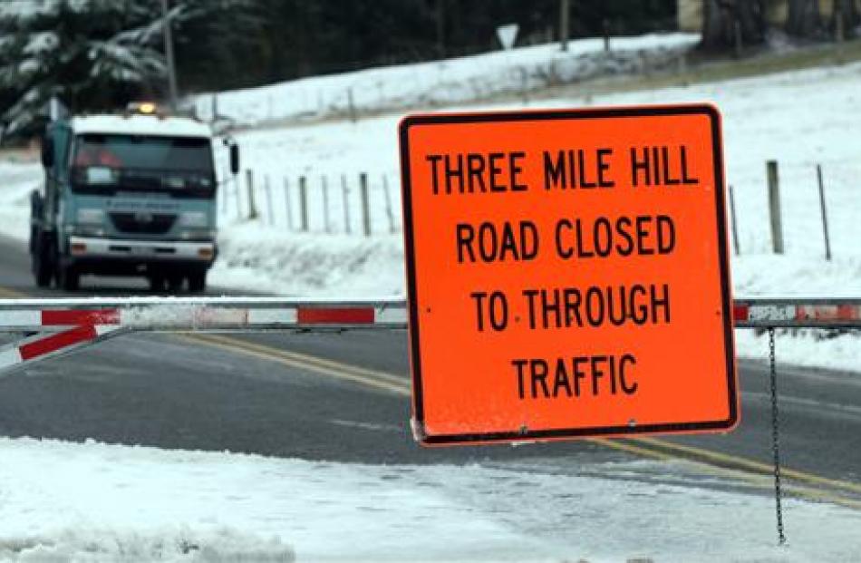 Three Mile Hill  Rd  was closed to traffic  yesterday morning. Photo by Peter McIntosh.