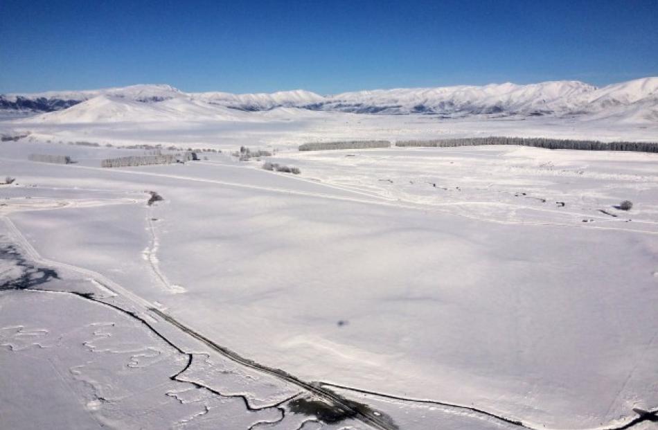 A farm on the outskirts of  Omarama township is blanketed in snow.