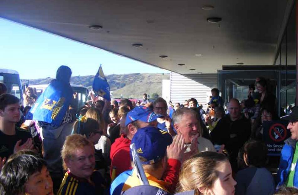 Fan faces in the crowd at the airport.