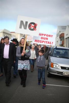 Waitaki district councillor Melanie Tavendale marches with Lachlan Wright (7) to protest proposed...