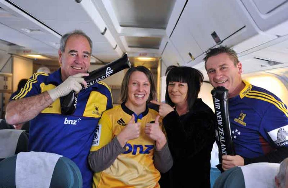 Keith Kippenberger, Andrea Vernall (only Hurricanes supporter on plane), and Sue and Keith Smith,...
