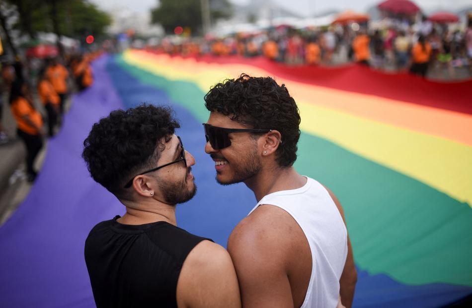 Revellers take part in the LGBTQ+ Pride Parade at Copacabana beach in Rio de Janeiro.
