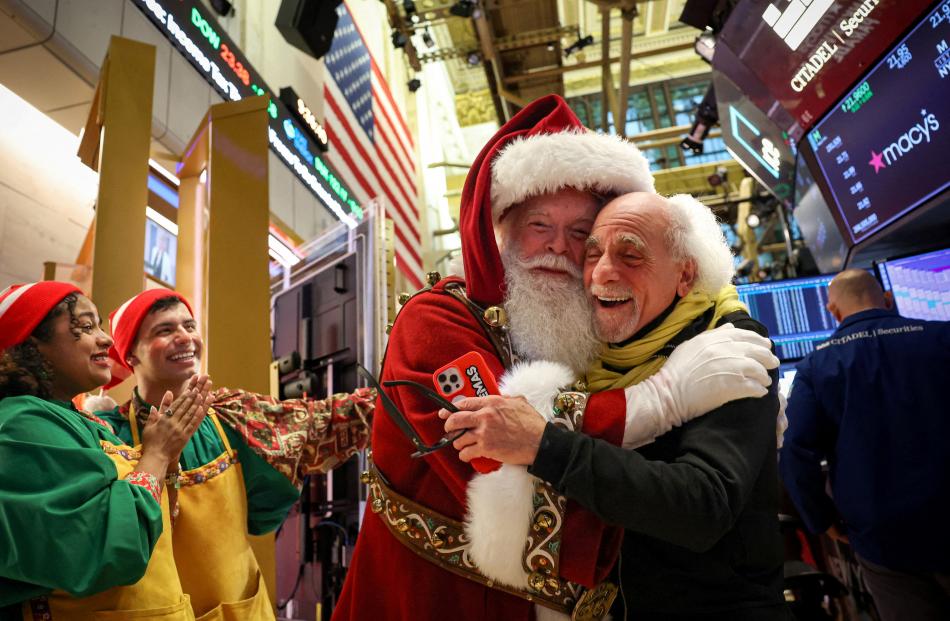 Macy’s Santa Claus is greeted by traders on the floor at the New York Stock Exchange.