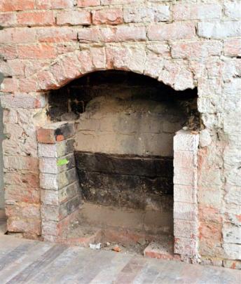 An old fireplace uncovered in the former corner bar.