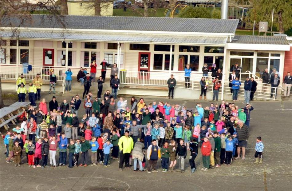 Clinton School pupils celebrate the arrival of the rescue helicopter.