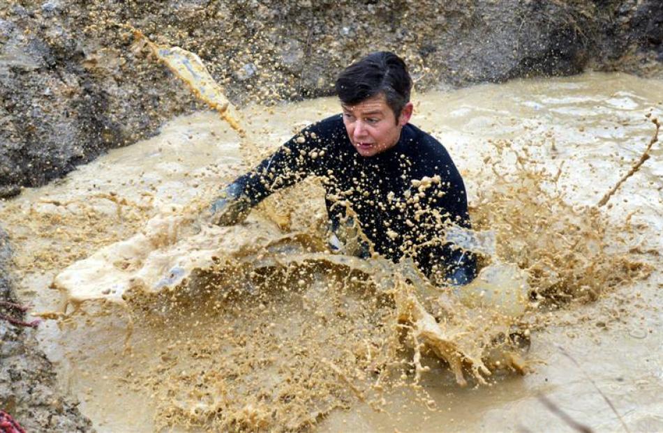 Jonathan Kemp, of Dunedin, gets a chilly surprise after jumping into a mud pit.
