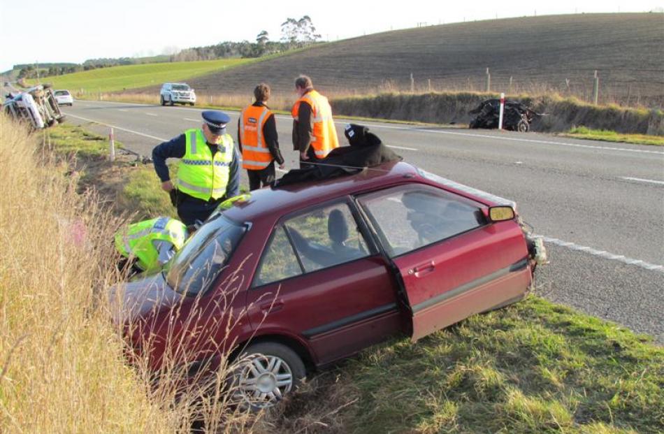 The main part of the  Mazda where it came to rest, across  State Highway 1 from the mangled front...