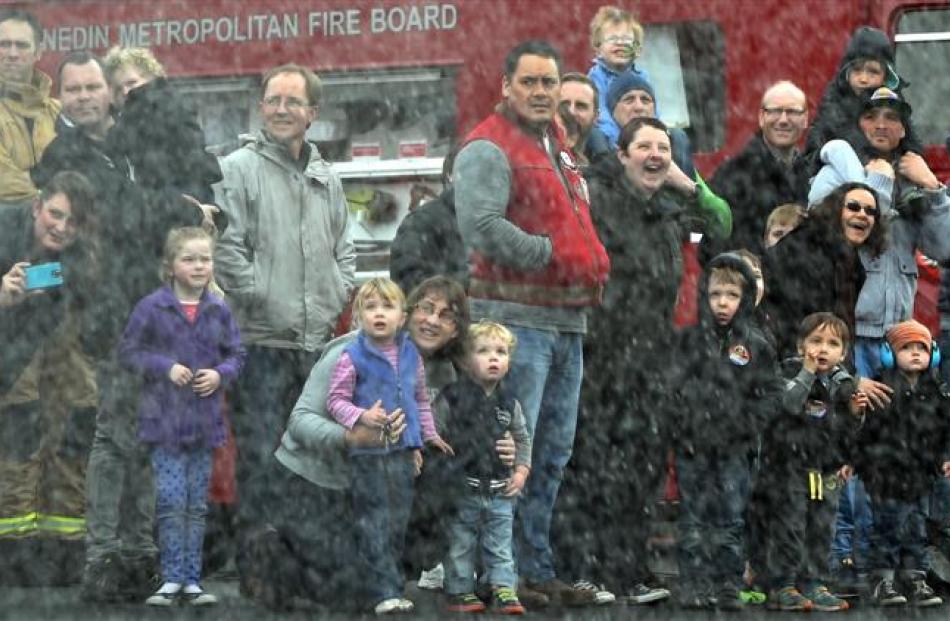 Those at the Dunedin Central Fire Station  stand back as water is sprayed from high pressure hoses.