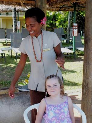 Lily McGrath (5), of Allanton, has her hair braided at Outrigger Fiji Beach Resort.