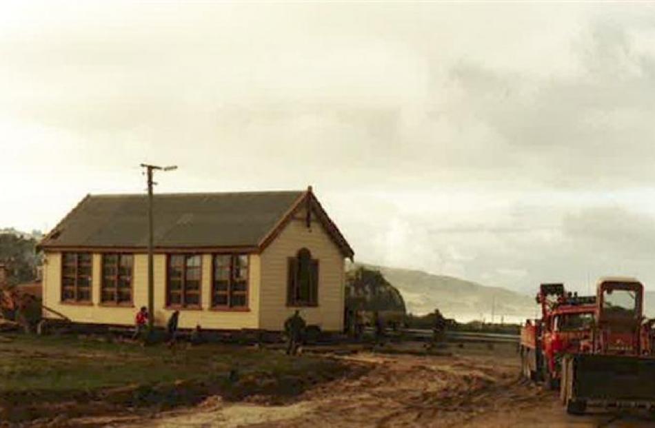 The historic Brighton schoolhouse being moved in 1982 to its present position in Brighton Rd....