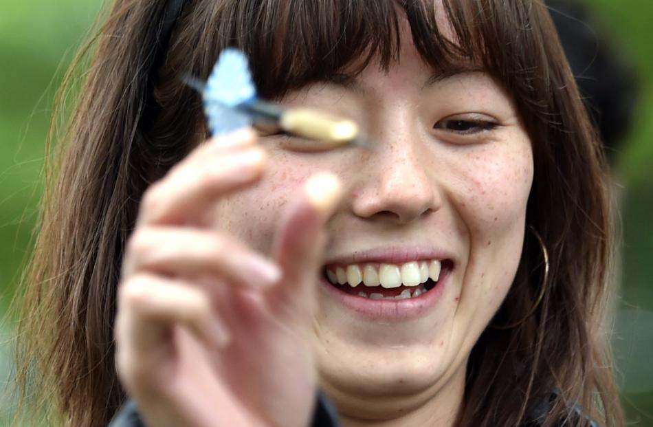 University of Otago student Alia Cauty, 19, of Auckland, in the dart-throwing contest at the...