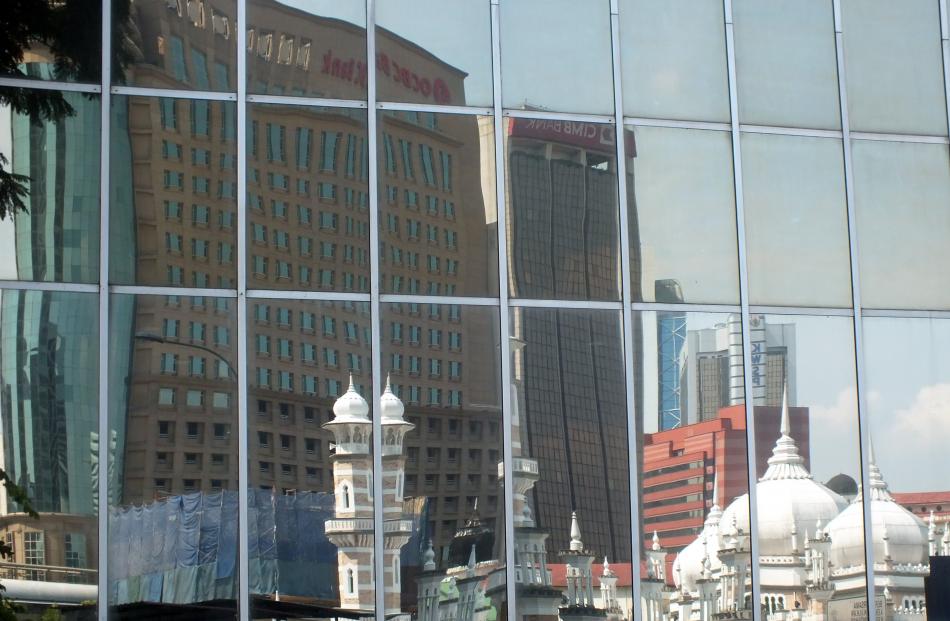 Buildings old and new are reflected in a Kuala Lumpur high-rise building.