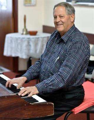 Rotarian John Wallis (70) entertains at the Mosgiel Rotary Club's annual book sale last Friday.