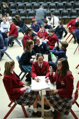 School pupils answer questions for spot prizes while quiz scores are tallied.