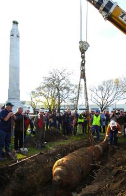 Ricky Manson, of Titan Cranes Ltd, balances the gun which has just been dug up at Queens Gardens...