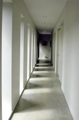 The recessed, cloister-like windows of the bedroom corridor capture the play of light and shade.