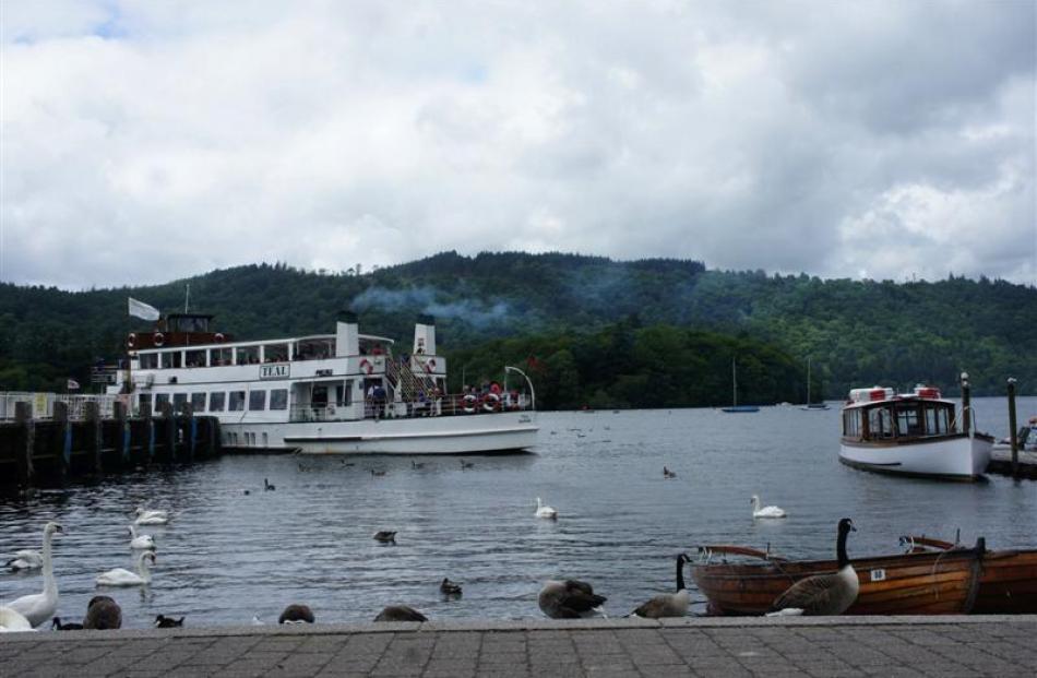 Tourists depart from Bowness for  a steam ferry ride across Britain's largest natural lake, Lake...