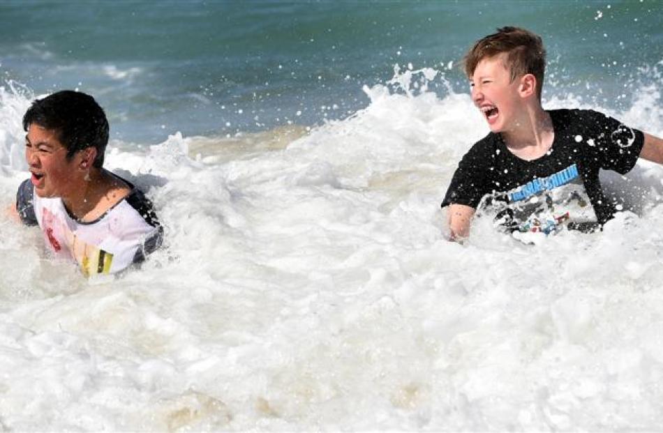 Christian Fogavai (12) and Johnny Butterfield (11), both of Dunedin,  take a dip at St Kilda Beach.
