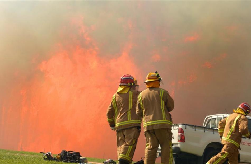 Firefighters prepare to attack the blaze in Morris Rd, Chain Hills, yesterday. Photo Stephen...