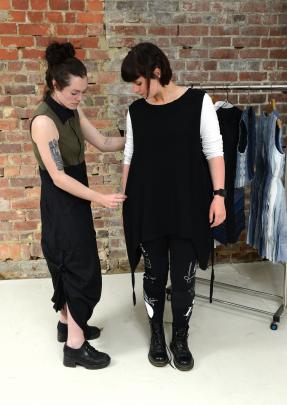 Designer Melanie Child, whose label is also Melanie Child, adjusts a piece on model Jess Blyth.