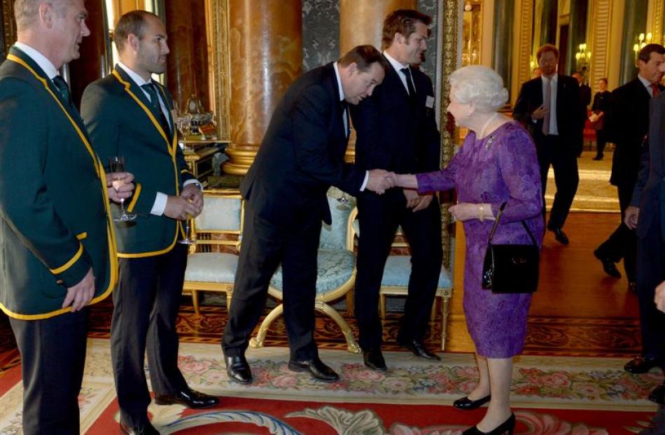All Black coach Steve Hansen meets Queen Elizabeth at a reception at Buckingham Palace to welcome...