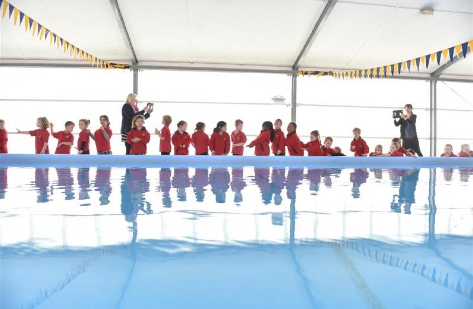 Mornington School pupils participate in a domino chain yesterday.