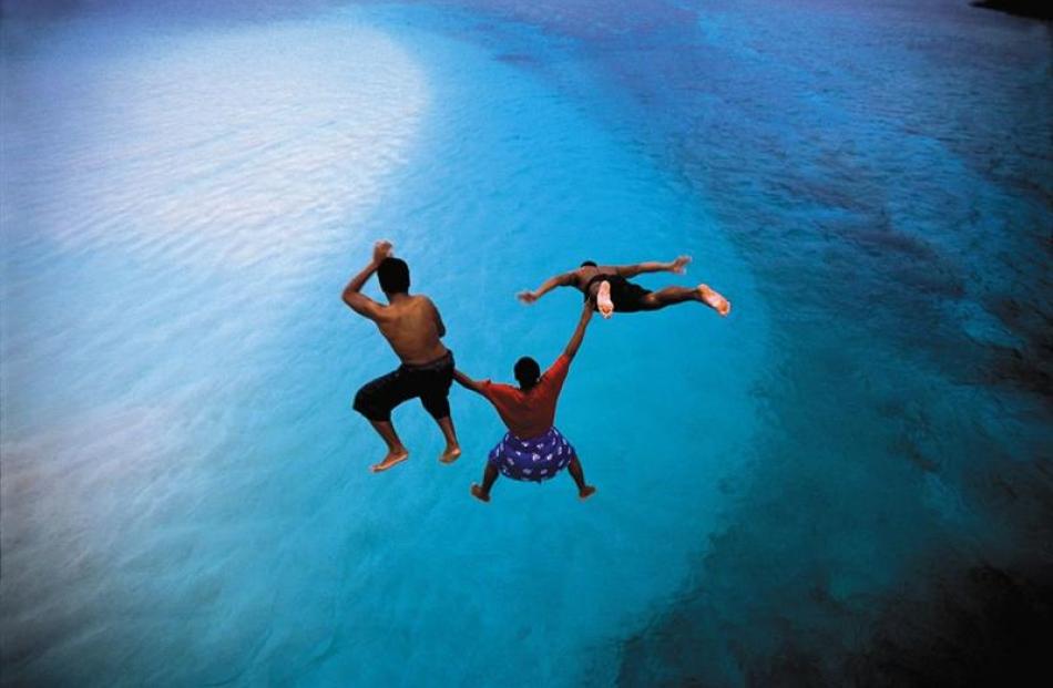 Locals jump into the harbour in the Manu'a Islands.