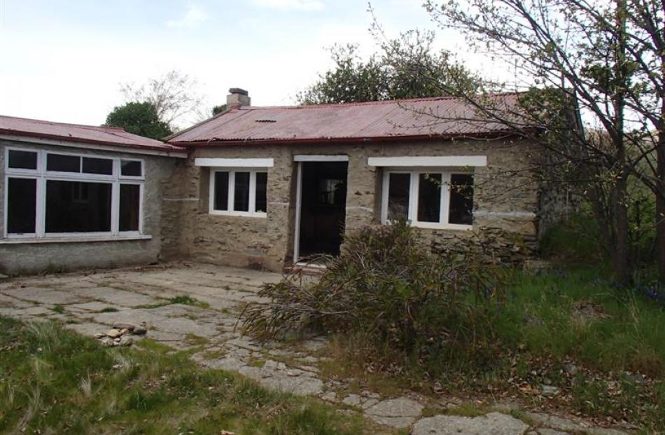 The cottage looks deceptively intact in this ''before'' photo, but the structure was no longer...