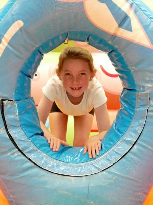 Eddison Anderson, 7, of Balclutha, peers through an inflatable Daddy Pig.