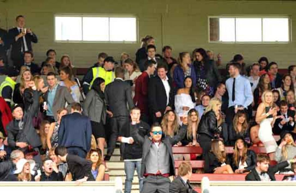 The crowd follows a race at Melbourne Cup race day at Wingatui yesterday.