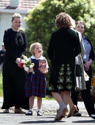 St Mary's School pupil Saffron Chisholm (5), of Mosgiel, gets ready to greet the Royal couple at...