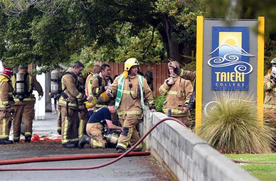 Some of the dozens of firefighters who attended yesterday's fire in the hall at Taieri College....