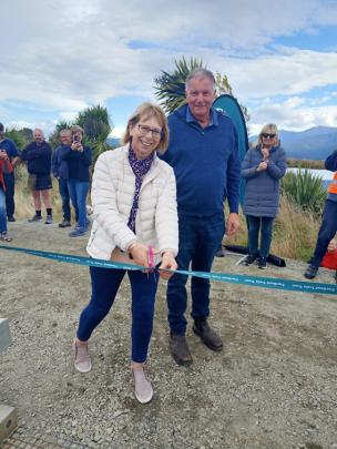 Suzanne Smith of Te Anau cuts the ribbon to the trail while husband Craig watches on. Suzanne and...