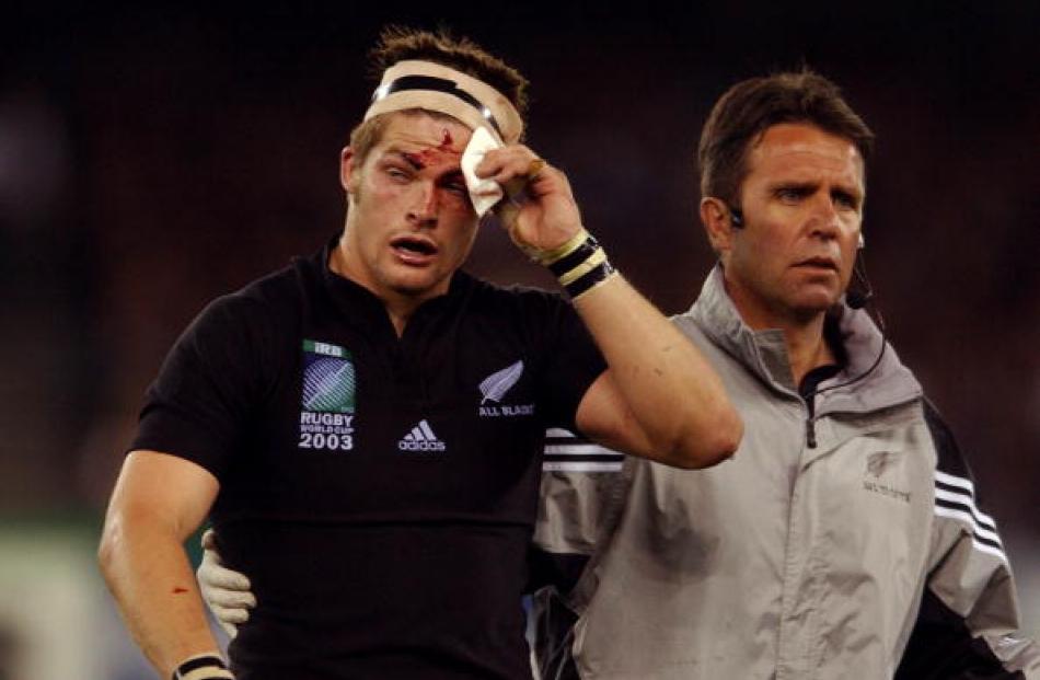 Bloodied in battle . . . McCaw is escorted to the blood bin for the second time by team Dr John...