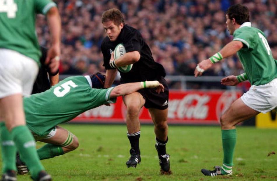 Fresh legs . . . McCaw runs at the Irish defence in his debut test at Lansdowne road in Dublin,...
