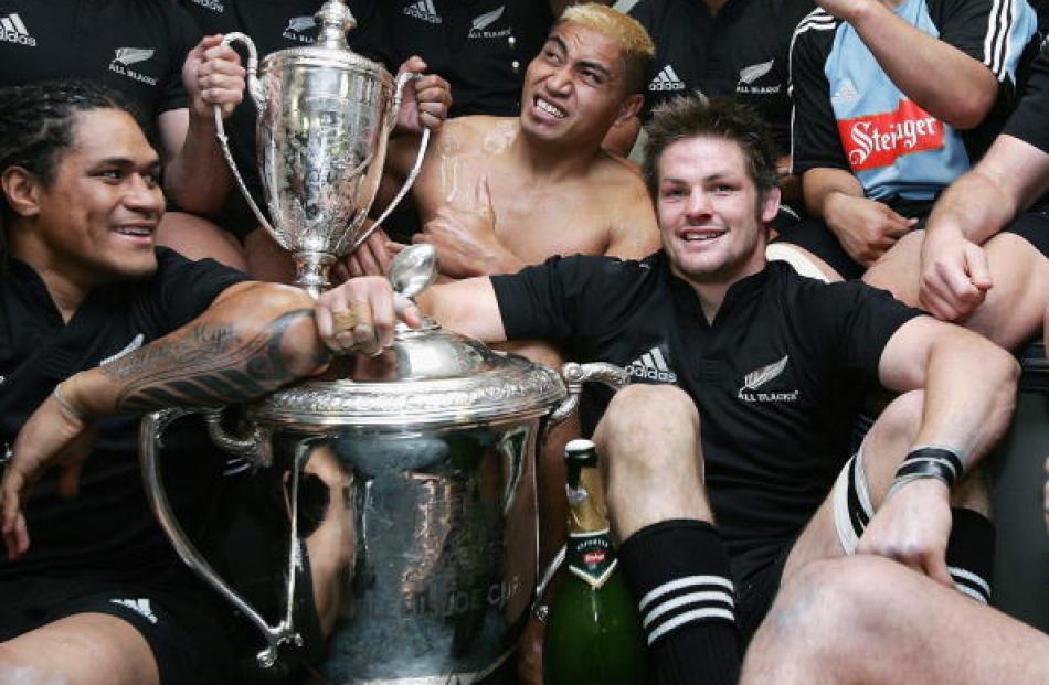With the boys . . . McCaw and teammates Rodney So'oialo (L) and Jerry Collins celebrate with the...